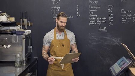 Man with clipboard coffeeshop.