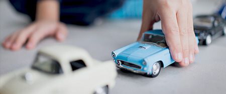 Boy playing with cars.